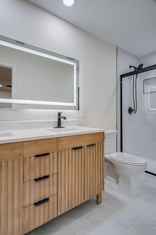 full bath featuring a shower stall, toilet, double vanity, and a sink