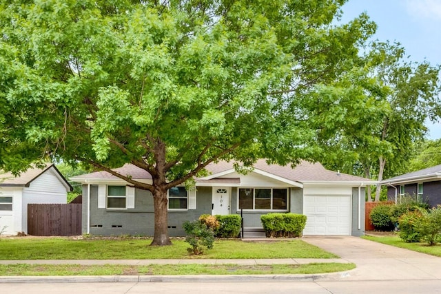ranch-style home featuring fence, a garage, crawl space, concrete driveway, and a front yard