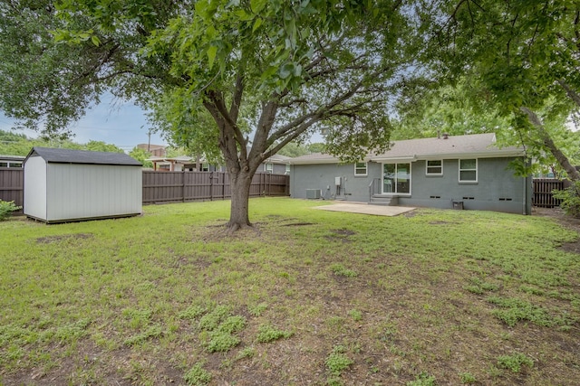 view of yard with an outbuilding, a shed, a patio area, entry steps, and a fenced backyard
