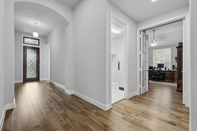 9800 Pikes Peak Pl, Oak Point, TX 75068 - entrance foyer with hardwood / wood-style flooring, arched walkways, baseboards, and a ceiling fan