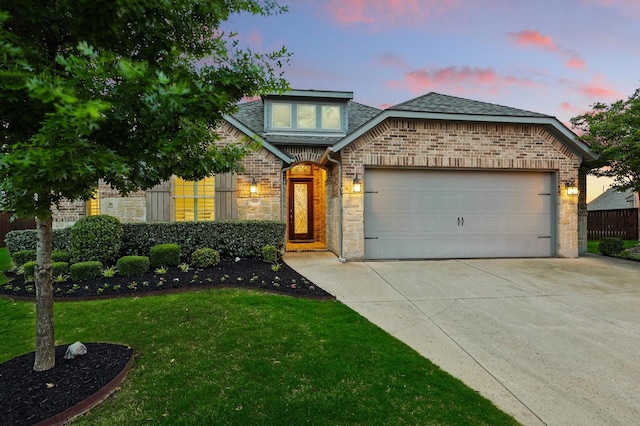 9800 Pikes Peak Pl, Oak Point, TX 75068 - view of front of home featuring concrete driveway, an attached garage, brick siding, a yard, and a shingled roof