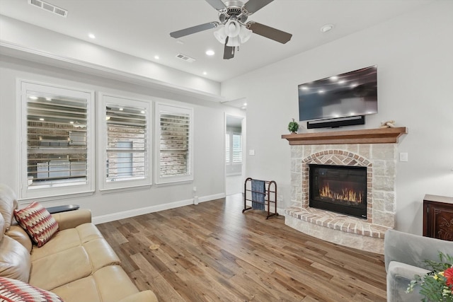 9800 Pikes Peak Pl, Oak Point, TX 75068 - living area with wood finished floors, ceiling fan, a stone fireplace, recessed lighting, and baseboards