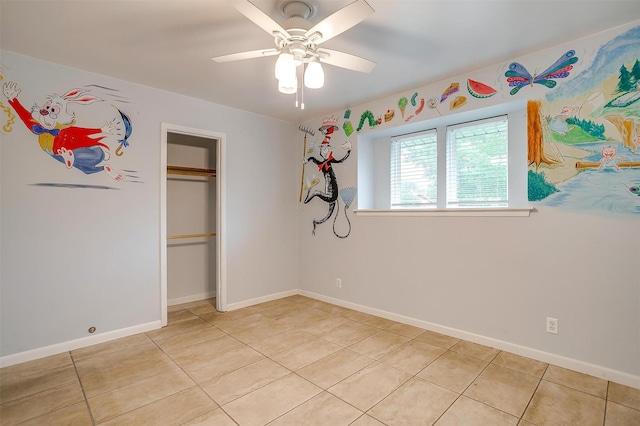 unfurnished bedroom with light tile patterned floors, baseboards, and a closet