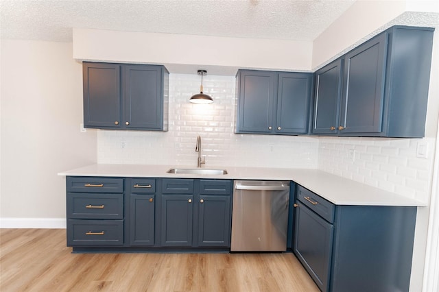 kitchen with a textured ceiling, light wood-type flooring, a sink, and dishwasher