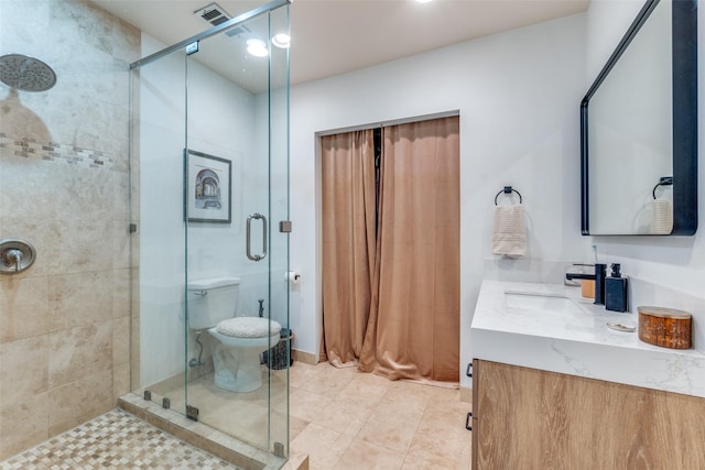 bathroom with a stall shower, vanity, visible vents, and tile patterned flooring