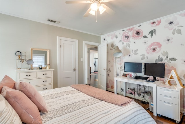 bedroom featuring crown molding, ceiling fan, visible vents, and dark wood finished floors