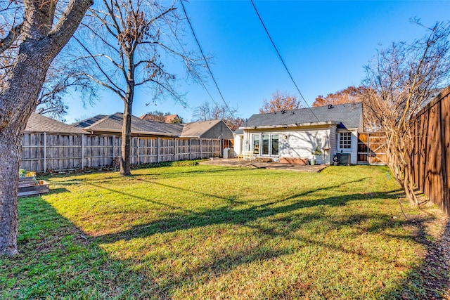 view of yard with a fenced backyard