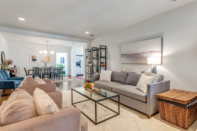 living area with light wood finished floors, a chandelier, recessed lighting, and visible vents