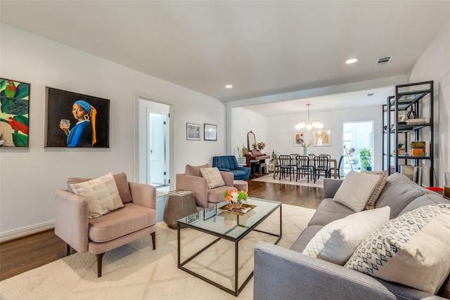 living room featuring recessed lighting, a notable chandelier, visible vents, and wood finished floors