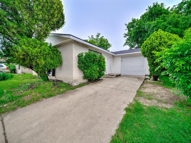 4250 Leland College Dr, Dallas, TX 75241 - view of front of property featuring concrete driveway, brick siding, and a garage