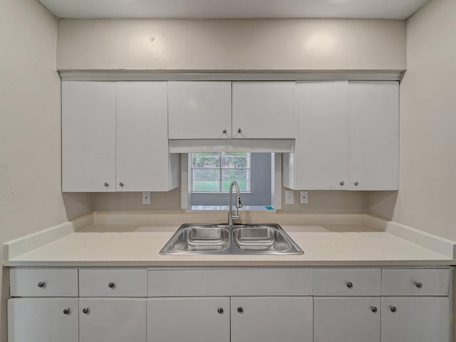 4250 Leland College Dr, Dallas, TX 75241 - kitchen with light countertops, white cabinets, and a sink