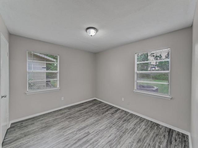 4250 Leland College Dr, Dallas, TX 75241 - empty room with baseboards, plenty of natural light, and wood finished floors