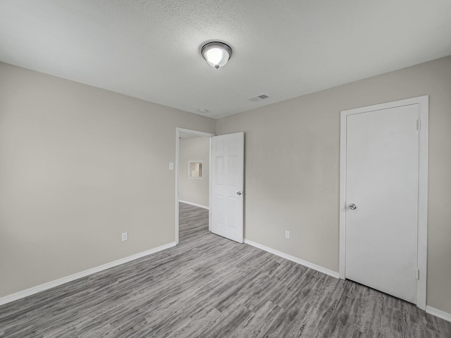 4250 Leland College Dr, Dallas, TX 75241 - unfurnished bedroom featuring baseboards, visible vents, and wood finished floors