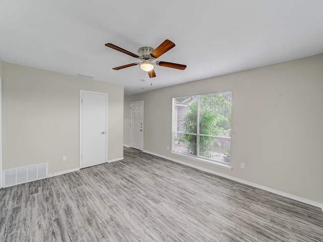 4250 Leland College Dr, Dallas, TX 75241 - unfurnished room with baseboards, ceiling fan, visible vents, and wood finished floors