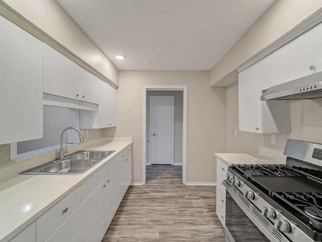 4250 Leland College Dr, Dallas, TX 75241 - kitchen featuring exhaust hood, a sink, stainless steel range with gas cooktop, light wood-style floors, and light countertops