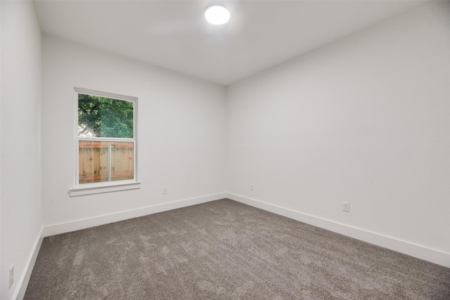 3904 De Maggio Ave, Dallas, TX 75210 - unfurnished room with baseboards and dark carpet