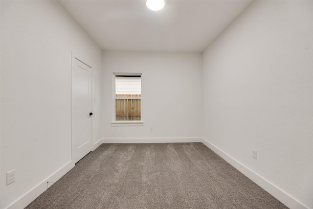 3904 De Maggio Ave, Dallas, TX 75210 - empty room featuring baseboards and dark carpet