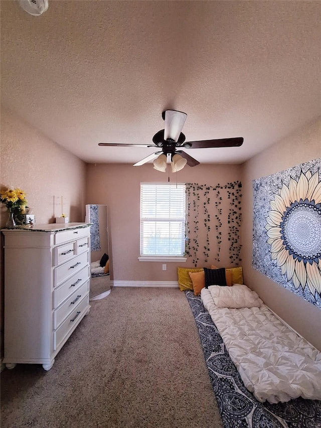 334 Miss Ellie Ln, Abilene, TX 79602 - carpeted bedroom featuring a textured ceiling, baseboards, and a ceiling fan