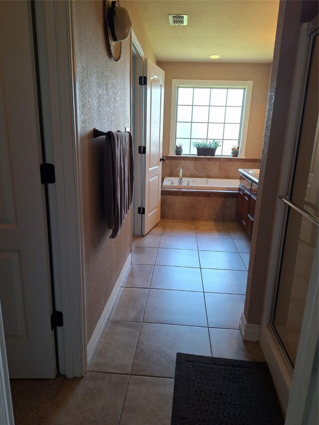 334 Miss Ellie Ln, Abilene, TX 79602 - bathroom featuring vanity, visible vents, tile patterned flooring, baseboards, and a bath