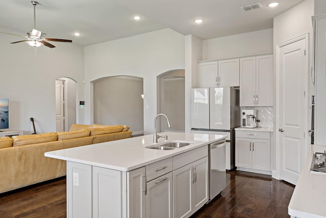 kitchen with a ceiling fan, stainless steel dishwasher, visible vents, a sink, and open floor plan