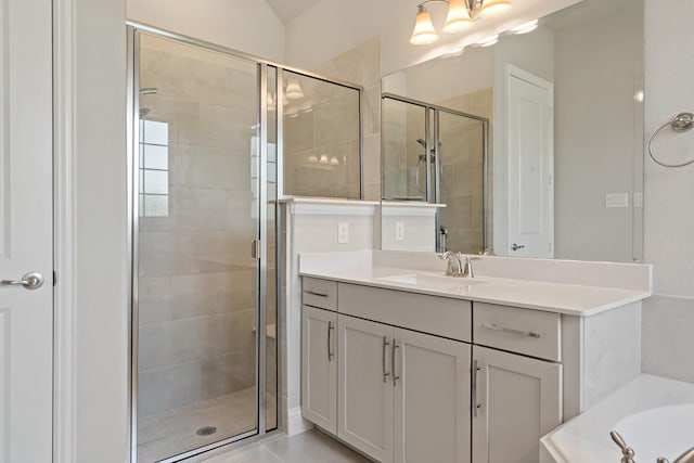 full bath with a shower stall, vanity, and a washtub