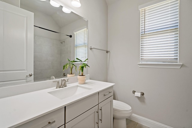 full bath featuring toilet, baseboards, tile patterned flooring, vanity, and a shower
