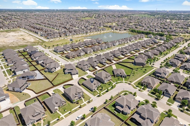 drone / aerial view featuring a water view and a residential view