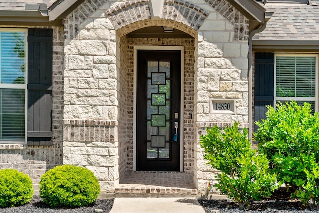 property entrance featuring stone siding