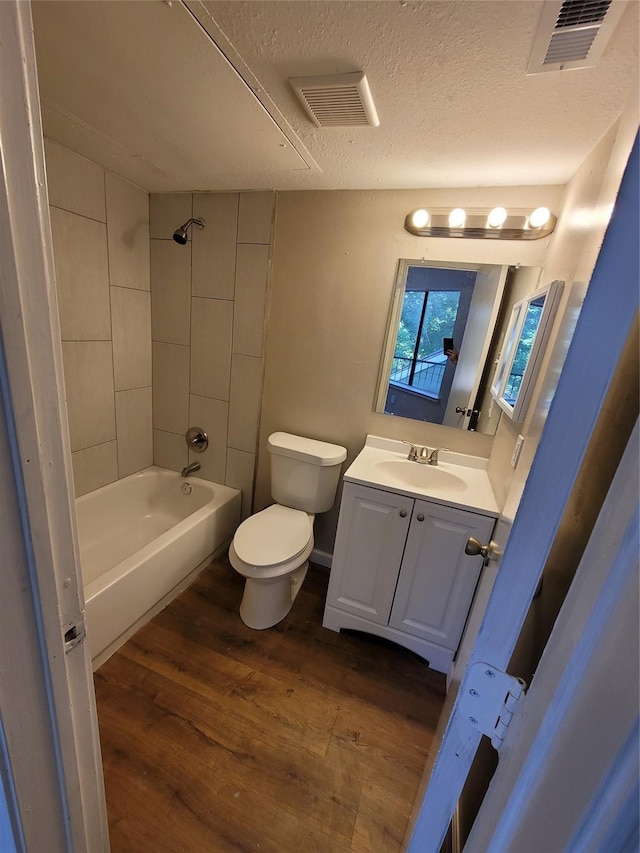 9815 Walnut St Unit 304, Dallas, TX 75243 - bathroom featuring  shower combination, toilet, visible vents, and wood finished floors