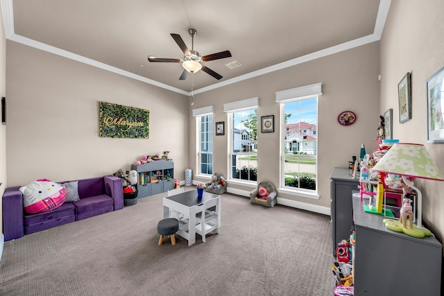 playroom with carpet, ceiling fan, crown molding, and baseboards