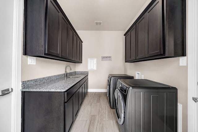 laundry area featuring cabinet space, baseboards, and washer and dryer