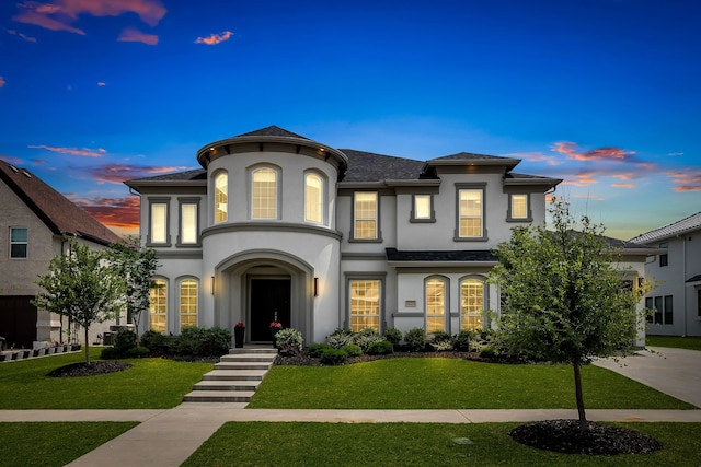 view of front of property with stucco siding and a front lawn