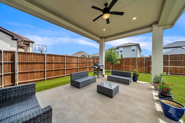 view of patio featuring a fenced backyard, grilling area, a ceiling fan, and an outdoor living space