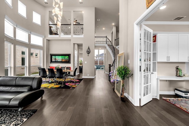 foyer with dark wood-style flooring, a high ceiling, plenty of natural light, a ceiling fan, and recessed lighting