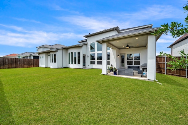 rear view of house with ceiling fan, stucco siding, outdoor lounge area, and a patio