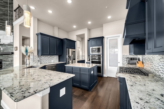 kitchen with a sink, stainless steel appliances, a peninsula, decorative backsplash, and recessed lighting