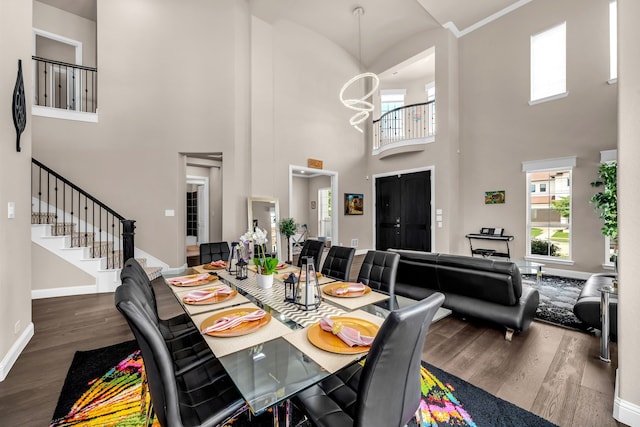 13393 Determine Dr, Frisco, TX 75035 - dining space featuring wood finished floors, a high ceiling, stairway, and a chandelier