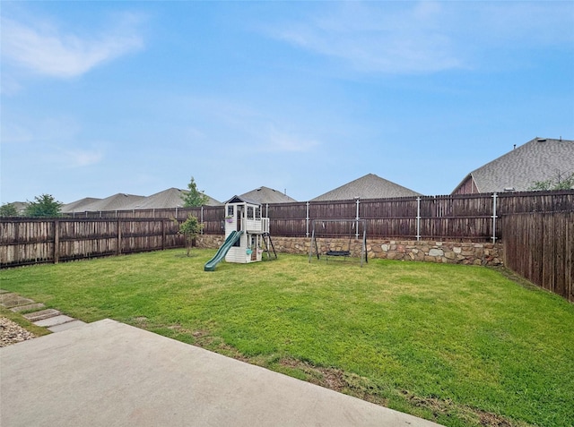 view of yard with a playground, a patio area, and a fenced backyard