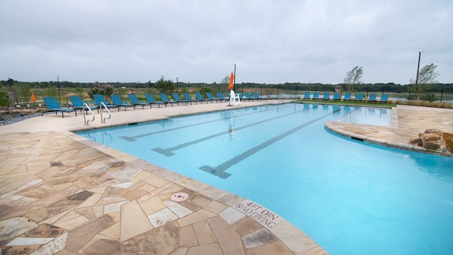 community pool featuring a patio area