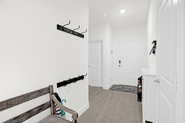 hallway with baseboards and light wood-style flooring