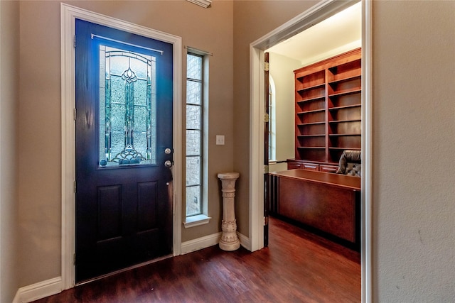 foyer with baseboards and dark wood finished floors