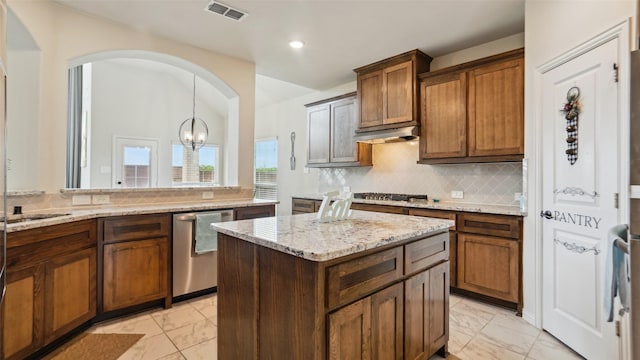 1106 Alaska Dr, Forney, TX 75126 - kitchen with light marble finish floors, appliances with stainless steel finishes, tasteful backsplash, light stone countertops, and recessed lighting