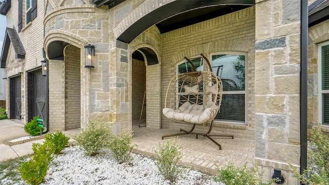 entrance to property with stone siding and brick siding