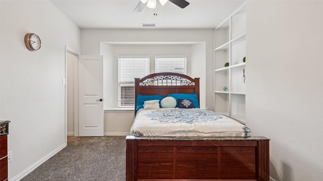 carpeted bedroom featuring baseboards, ceiling fan, and visible vents