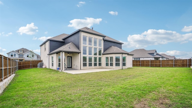 back of property featuring central AC, ceiling fan, a fenced backyard, a yard, and a patio area