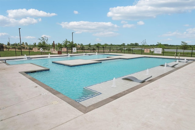 community pool featuring a patio area and fence
