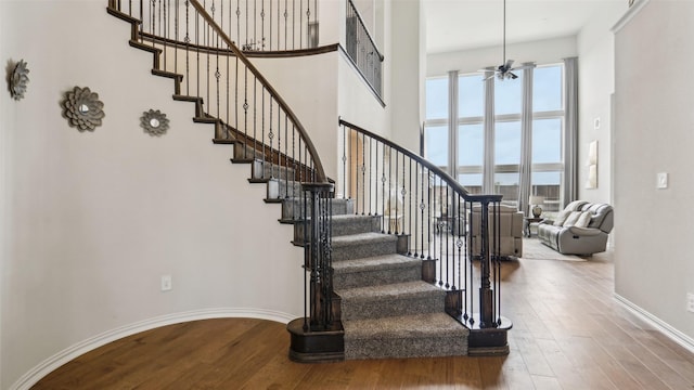 1106 Alaska Dr, Forney, TX 75126 - stairs with a towering ceiling, wood finished floors, ceiling fan, and baseboards