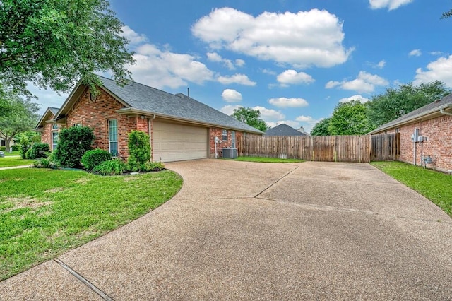 view of side of home featuring a lawn, brick siding, fence, cooling unit, and concrete driveway