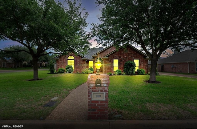 view of front facade featuring a yard and brick siding