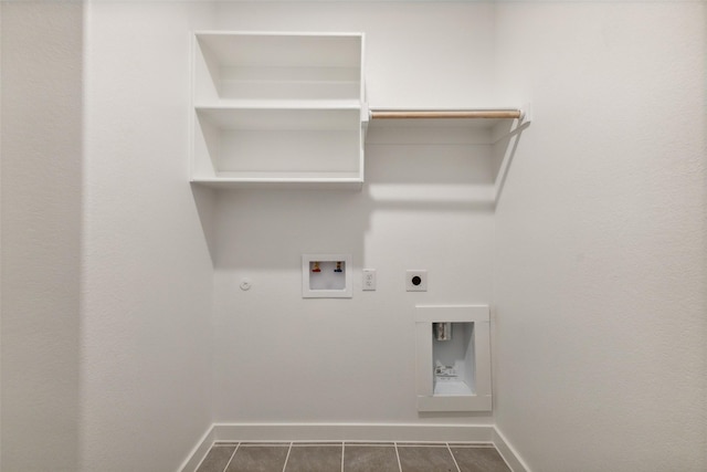 laundry room with hookup for a gas dryer, laundry area, baseboards, and electric dryer hookup